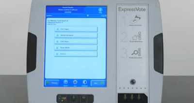 White ExpressVote voting machine with blue and white screen showing contests