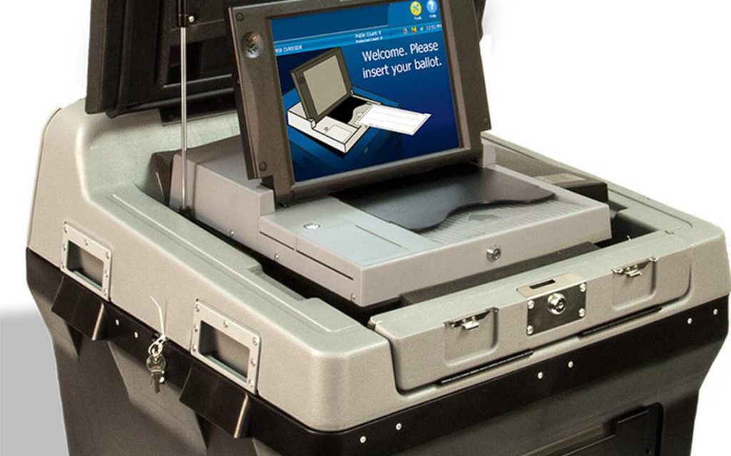 Gray scanner on top of black base has a blue touch screen that reads "Welcome, Please insert your ballot."