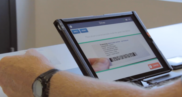 Poll worker scanning voters ID on Precinct Central electronic poll book