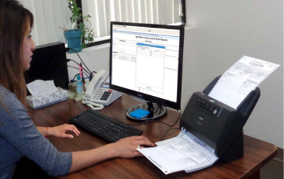 Person at desk using OVCS mini scanner